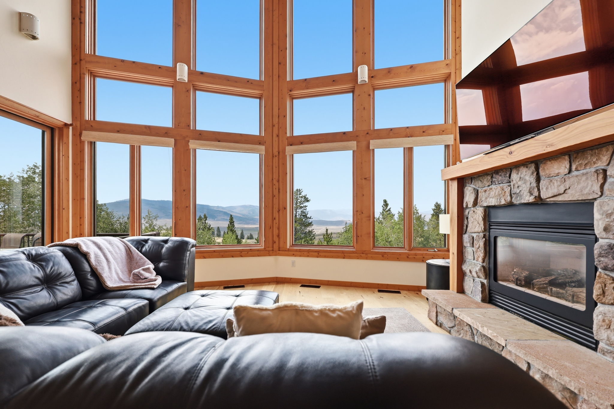 Great room with stone fireplace and window wall