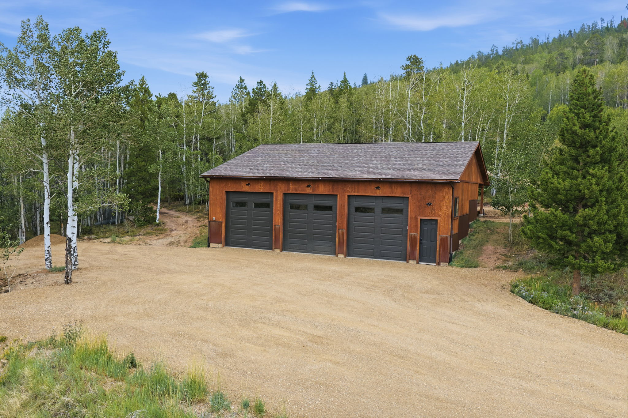 The 2023 shop, three bays on the gravel apron
